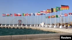 The 2022 World Cup countdown clock and national flags are seen in Doha, Qatar, June 16, 2022.
