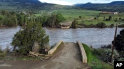 A washed out bridge shown along the Yellowstone River Wednesday, June 15, 2022, near Gardiner, Mont. (AP Photo/Rick Bowmer)