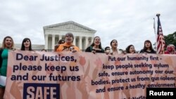 Demonstrators call on the United States Supreme Court to overturn the "Remain in Mexico" policy in response to Biden v. Texas, in Washington, June 21, 2022. 