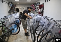 Volodymyr Pozolotin arranges bikes at a bike shop in Kramatorsk, amid Russia's invasion of Ukraine, July 2, 2022.