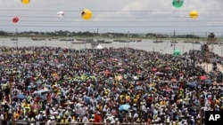 A crowd watches the opening of Bangladesh's longest bridge, which took eight years to build on the Padma River on the outskirts of Dhaka, Bangladesh, June 25, 2022.