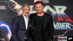 L'acteur australien Chris Hemsworth, à droite, et le réalisateur néo-zélandais Taika Waititi posent sur le tapis rouge pour la première du film "Thor : Love and Thunder" à Sydney, en Australie, le 27 juin 2022.