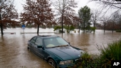 A car sits semi-submerged in flood waters at Camden on the outskirts of Sydney, Australia, July 4, 2022.