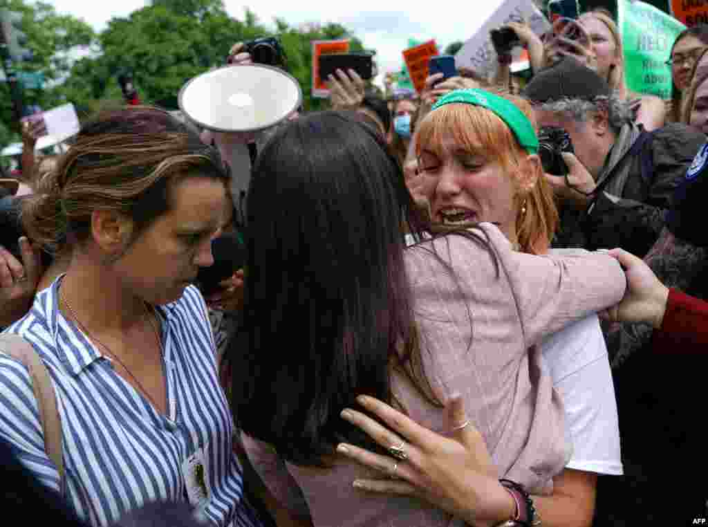 Abortion-rights activists react outside the U.S. Supreme Court in Washington.