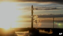 In this photo released by Rocket Lab, Rocket Lab's Electron rocket sits on the launch pad on the Mahia peninsula in New Zealand on May 17, 2022. (Rocket Lab via AP)