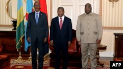 Rwanda President Paul Kagame, left, Angola President Joao Lourenco, center, and Democratic Republic of Congo President Felix Tshisekedi pose for a photograph in Luanda, Angola, on July 6, 2022, as they meet for talks after an upsurge in violence in eastern DRC. 