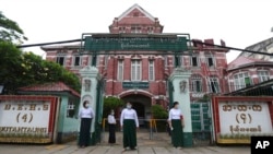 FLE - Teachers wearing face masks wait for students' arrival at a high school in Yangon, Myanmar, July 21, 2020.