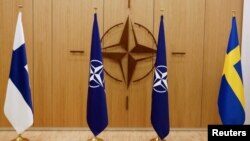 FILE - The flags of Finland, NATO and Sweden are seen during a ceremony to mark Sweden's and Finland's application for membership in Brussels, Belgium, May 18, 2022. 