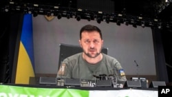 Ukrainian President Volodymyr Zelenskyy speaks via video at the Glastonbury Festival in Worthy Farm, Somerset, England, June 24, 2022.