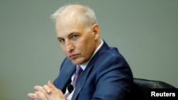 FILE - US Assistant Attorney General for National Security Matthew Olsen looks on as he delivers remarks on U.S. Department of Justice policy in Arlington, Va., Feb. 23, 2022. 