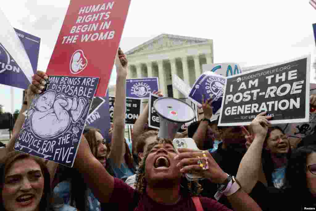 Anti-abortion demonstrators celebrate outside the U.S. Supreme Court in Washington.
