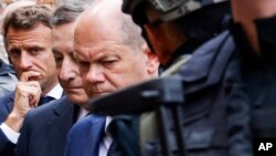 French President Emmanuel Macron, left, Italian Prime Minister Mario Draghi, center, and German Chancellor Olaf Scholz visit Irpin, Ukraine, June 16, 2022, in a show of collective European support for the Ukrainian people in the war with Russia.