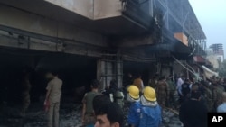 Emergency workers gather at the scene of a car bomb in northern city of Irbil, Iraq, April 17, 2015.