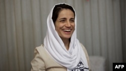 FILE - Iranian lawyer Nasrin Sotoudeh smiles at her home in Tehran, Sept. 18, 2013.