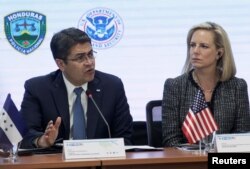 Honduran President Juan Orlando Hernandez speaks beside U.S. Secretary of Homeland Security Kirstjen Nielsen during a multilateral meeting at the Honduran Ministry of Security in Tegucigalpa, Honduras, March 27, 2019.