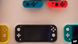 FILE - In this Thursday, Jan, 23, 2020 file photo, Nintendo Switch game consoles are on display at Nintendo's official store in the Shibuya district of Tokyo. 