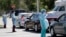 Healthcare workers screen people at a drive-through COVID-19 testing site, March 20, 2020, at the Doris Ison Health Center in Miami, Florida.