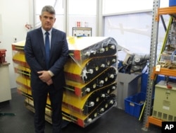 Peter Foley, Australian Transport Safety Bureau director of Malaysian Flight 370 search operations, stands beside a stack of replica wing flaps, Aug. 18, 2016, at the bureau's headquarters in Canberra, Australia.