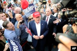 Republican presidential candidate Donald Trump, center, greets supporter after speaking at a campaign event in Los Angeles, Sept. 15, 2015.