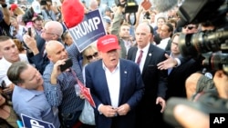 FILE - Republican presidential candidate Donald Trump, center, greets supporter after speaking at a campaign event in Los Angeles, Sept. 15, 2015.