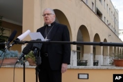 Brisbane's Archbishop Mark Coleridge reads a statement to the media on the conviction of Australian Cardinal George Pell for molesting two choir boys in the 1970s, in Rome, Feb. 26, 2019.