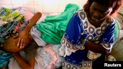 FILE - Jonas Lukano, 60, who has diabetes, is watched over by his sister at the state general hospital in Congo's capital of Kinshasa.