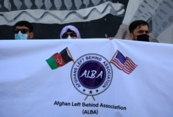 Former Afghan interpreters hold placards during a demonstrations against the US government, in front of the US Embassy in Kabul, Afghanistan, Friday, June 25, 2021.