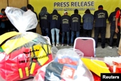 Some of the more than 140 men detained after a raid on what authorities described as a gay prostitution ring being run out of an entertainment venue are shown to the media at a police station in Jakarta, Indonesia, May 22, 2017.