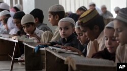 Pakistani children attend lessons at a madrassa, or a religious school, to learn Quran, in Karachi, Sept. 2, 2015. 
