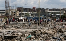 Residents gather during a clash over the demolition of homes at the Mukuru Kwa Njenga informal settlements in Nairobi, Dec. 27, 2021.