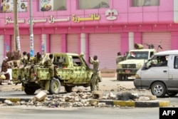 FILE - Sudanese soldiers stand guard a street in Khartoum, June 9, 2019. Sudanese police fired tear gas at protesters taking part in the first day of a civil disobedience campaign, called in the wake of a deadly crackdown on demonstrators.