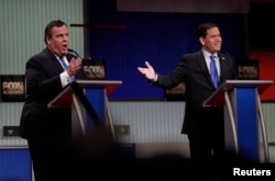 Republican U.S. presidential candidate Governor Chris Christie, left, and Senator Marco Rubio speak simultaneously during the Fox Business Network Republican presidential candidates debate in North Charleston, S.C., Jan. 14, 2016.