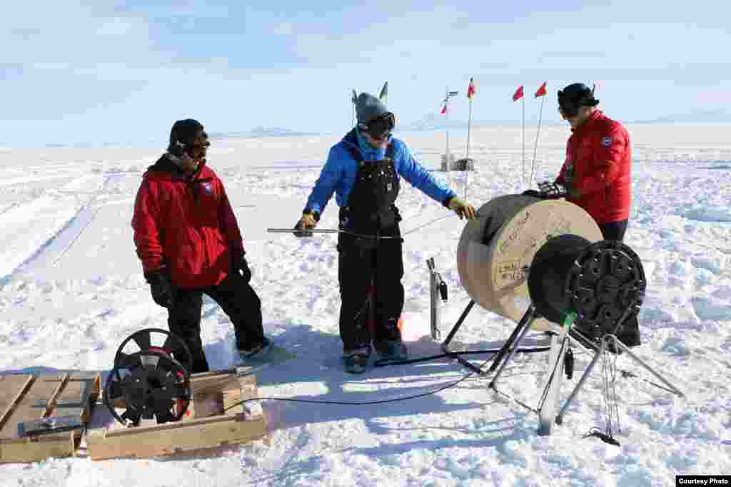The fiber optic and pressure sensor cables were quickly lowered down the hole to the ocean just before the ocean water in the access borehole froze. Once frozen in place, the cables were connected to the surface instrumentation package of lasers, detectors, data loggers and satellite communication gear. (Victor Zagorodnov) 