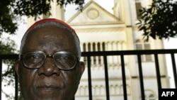 FILE - Cameroon's Christian Tumi poses in front of his diocese in Douala, Oct. 7, 2004.