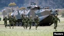 Soldiers of Japanese Ground Self-Defense Force (JGSDF)'s Amphibious Rapid Deployment Brigade, Japan's first marine unit since World War Two, take part in a drill at JGSDF's Camp Ainoura in Sasebo, on the southwest island of Kyushu, Japan.