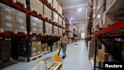 FILE - An employee works inside the warehouse of Alembic Pharmaceutical Limited's plant in Halol, in the western state of Gujarat, India, July 14, 2017. 