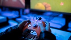 A boy plays a game on Xbox at the Paris Games Week in Paris, Friday, Nov. 3, 2017. (AP Photo/Kamil Zihnioglu)