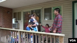 Dowlati with his family at their apartment in Riverdale, MD. Two of the children came over from Afghanistan. The third was born here. (J. Soh/VOA)