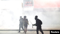 Anti-government protesters react as police fire tear gas during a demonstration, in Hong Kong, Nov. 2, 2019.