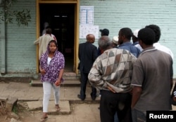 A woman leaves after casting her vote at a polling station, as Ethiopia's national election kicks off in capital Addis Ababa, May 24, 2015.