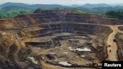 FILE - Excavators and drillers at work in an open pit at Tenke Fungurume, a copper and cobalt mine 110 km (68 miles) northwest of Lubumbashi in Congo's copper-producing south, Jan. 29, 2013. 