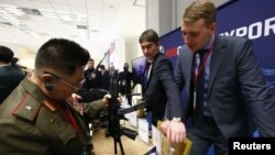 FILE - A member of the Norh Korean armed forces inspects a submachine gun "Vityaz-SN" at the stand of Russian state-owned arms exporter Rosoboronexport during the annual Moscow Conference on International Security (MCIS) in Moscow, Russia, April 4, 2018.