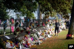 Mourners paying their respects at a makeshift memorial at the Botanical Gardens in Christchurch, New Zealand, March 16, 2019.