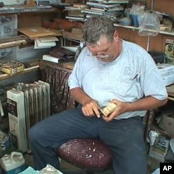 Bob Jobes hard carves a wooden decoy duck.