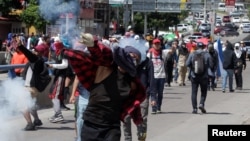 Demonstrators take part in a protest against Honduran president Juan Orlando Hernandez, in Tegucigalpa, Honduras, Oct. 24, 2019. 