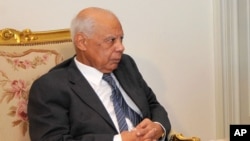 In this image released by the Egyptian Presidency, Hazem el-Beblawi meets with interim President Adly Mansour, unseen, in Cairo, July 9, 2013. 
