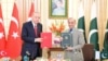 Turkish President Recep Tayyip Erdogan, left, and Pakistani Prime Minister Shahbaz Sharif hold copies of a joint declaration at the Pakistan-Turkey High Level Strategic Cooperation Council in Islamabad, Feb. 13, 2025. (Ministry of Information and Broadcasting, Pakistan)