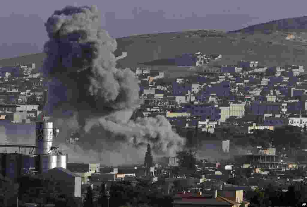 Smoke rises following an airstrike by the US-led coalition during fighting between Syrian Kurds and the&nbsp; Islamic State militants, as seen from the outskirts of Suruc, on the Turkey-Syria border, Oct. 10, 2014. 