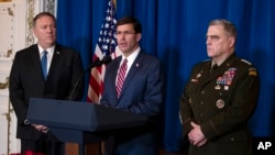 Secretary of State Mike Pompeo (L) and Chairman of the Joint Chiefs of Staff Gen. Mark Milley (R) listen as Secretary of Defense Mark Esper delivers a statement, at President Donald Trump's Mar-a-Lago estate, in Palm Beach, Florida, Dec. 29, 2019.