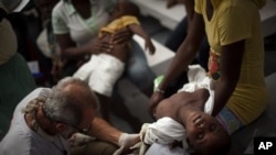 A child suffering cholera symptoms is checked by a doctor at the Doctors Without Borders temporary hospital in Port-au-Prince, Haiti, 16 Nov 2010